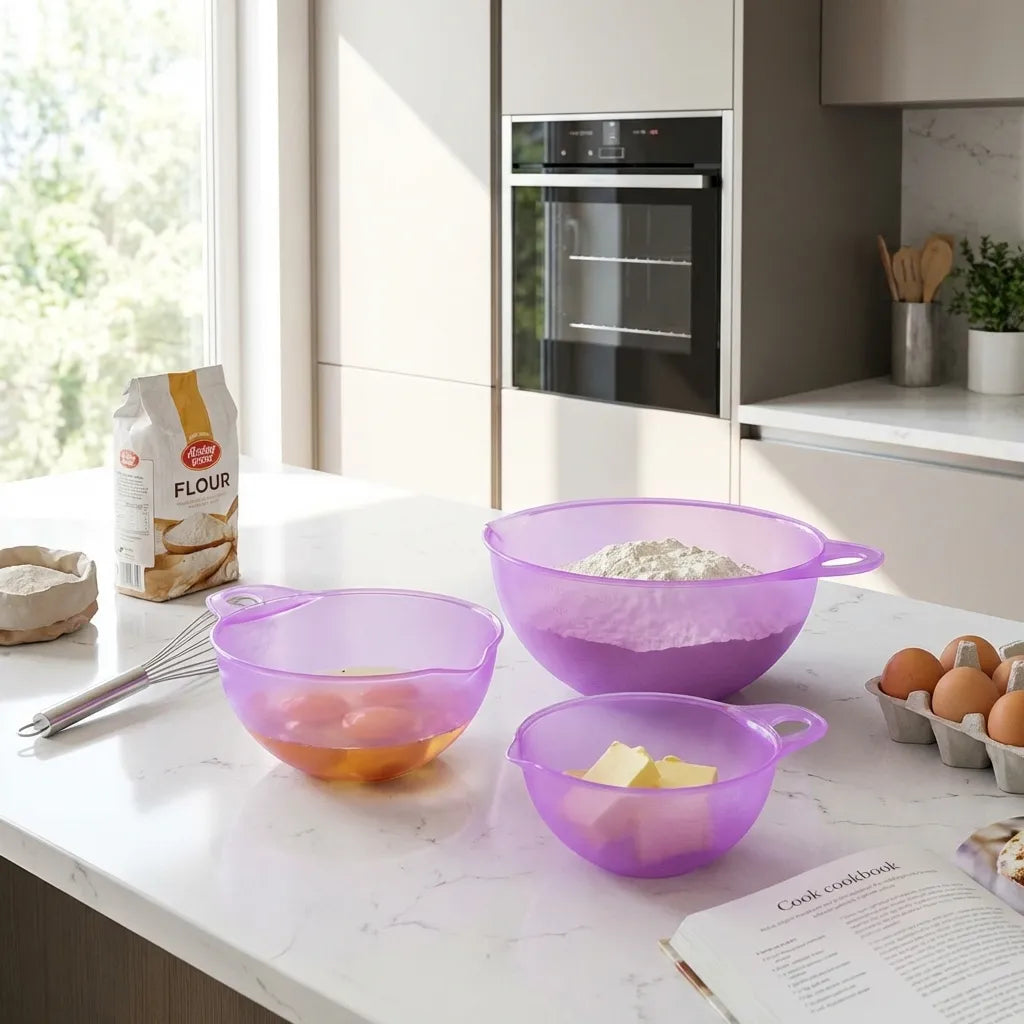Purple mixing bowl set with multiple bowls and loop handles on countertop