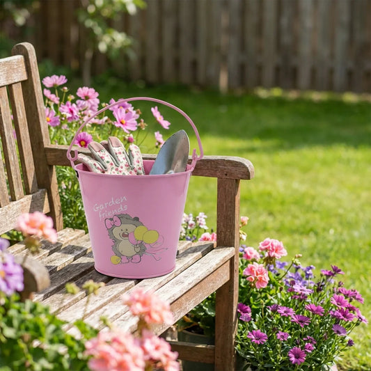 Pink metal bucket planter with cartoon rabbit graphic and handle