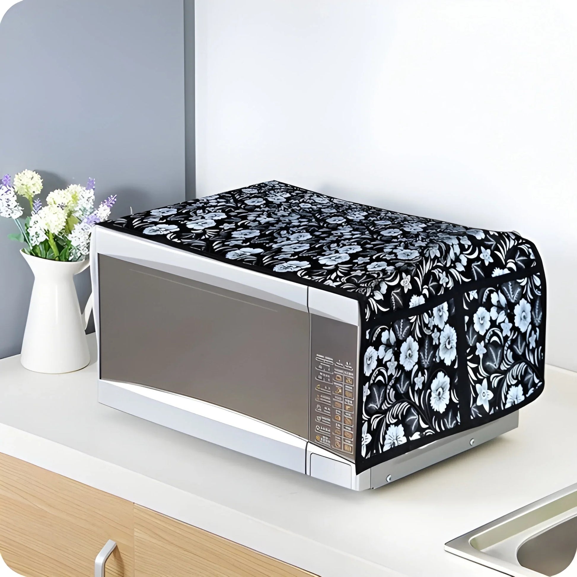 Microwave oven cover with black background and white floral pattern, padded wrap-style
