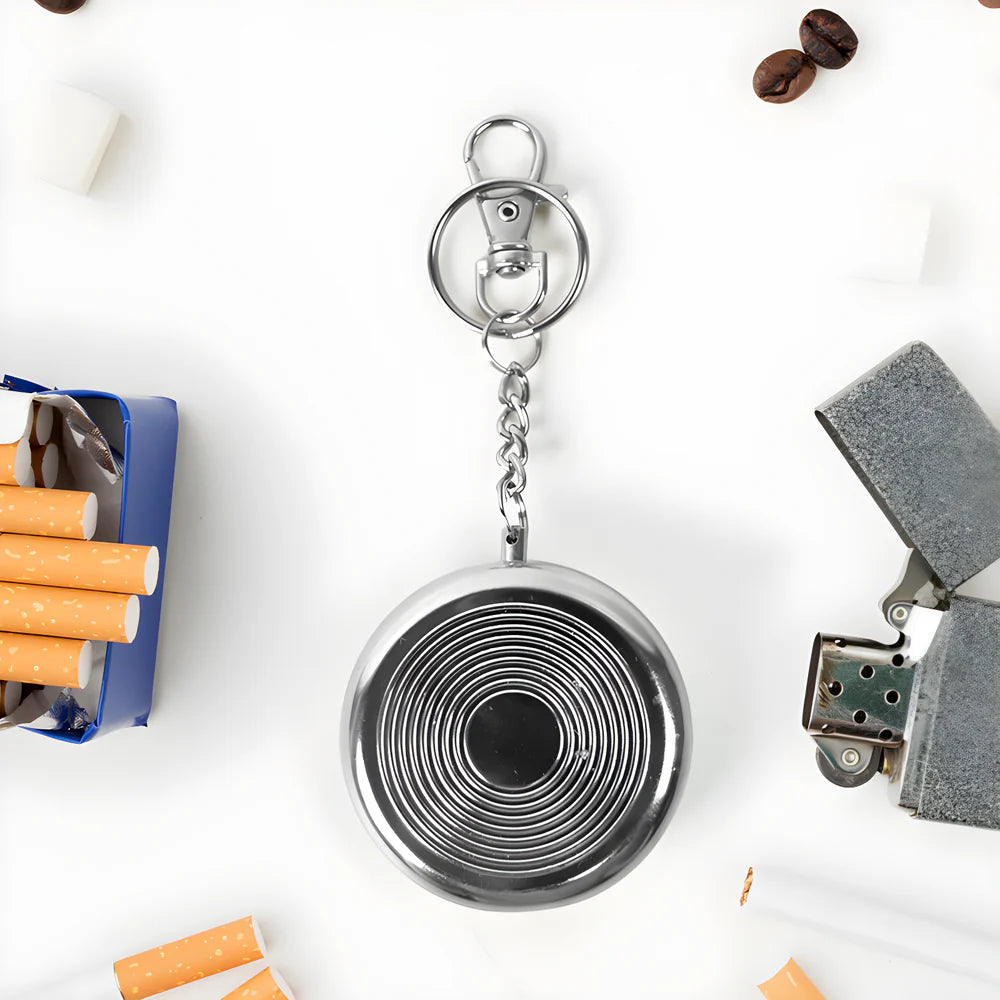 Round metal mini pocket ashtray keychain with circular spiral grooves and ring clasp