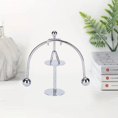 Mini steel balance toy with arched frame and two hanging metal balls