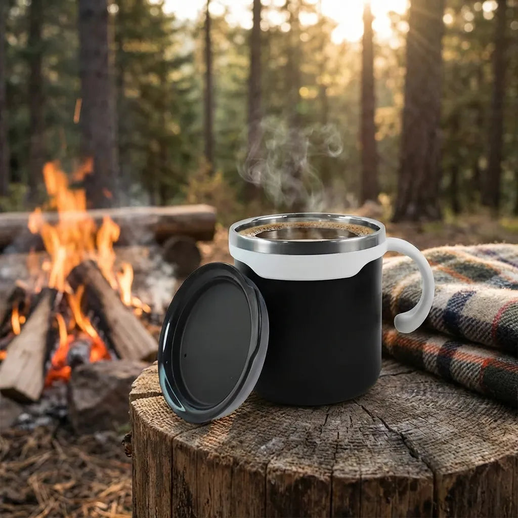Mocha mug set: black insulated mug with silver rim and hinged lid beside campfire backdrop