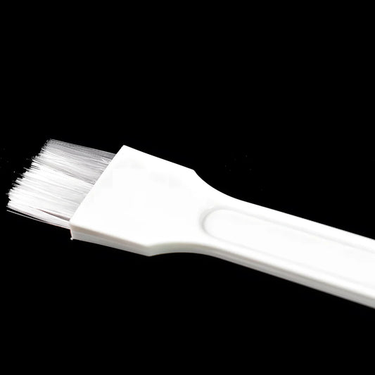 White keyboard cleaning brush with soft bristles and angled handle