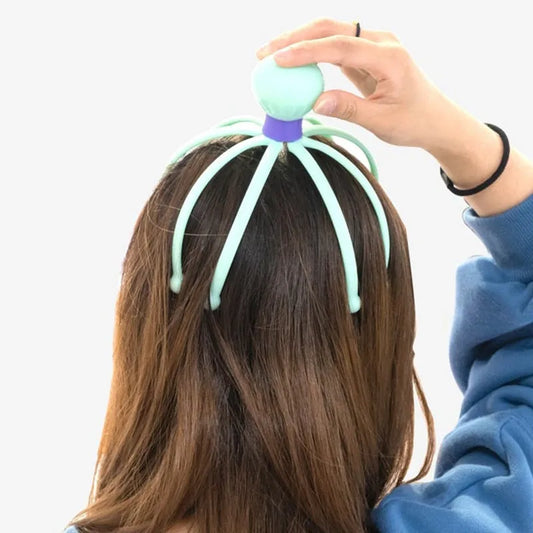 Octopus scalp massager with teal octopus head and tentacle fingers held to hair