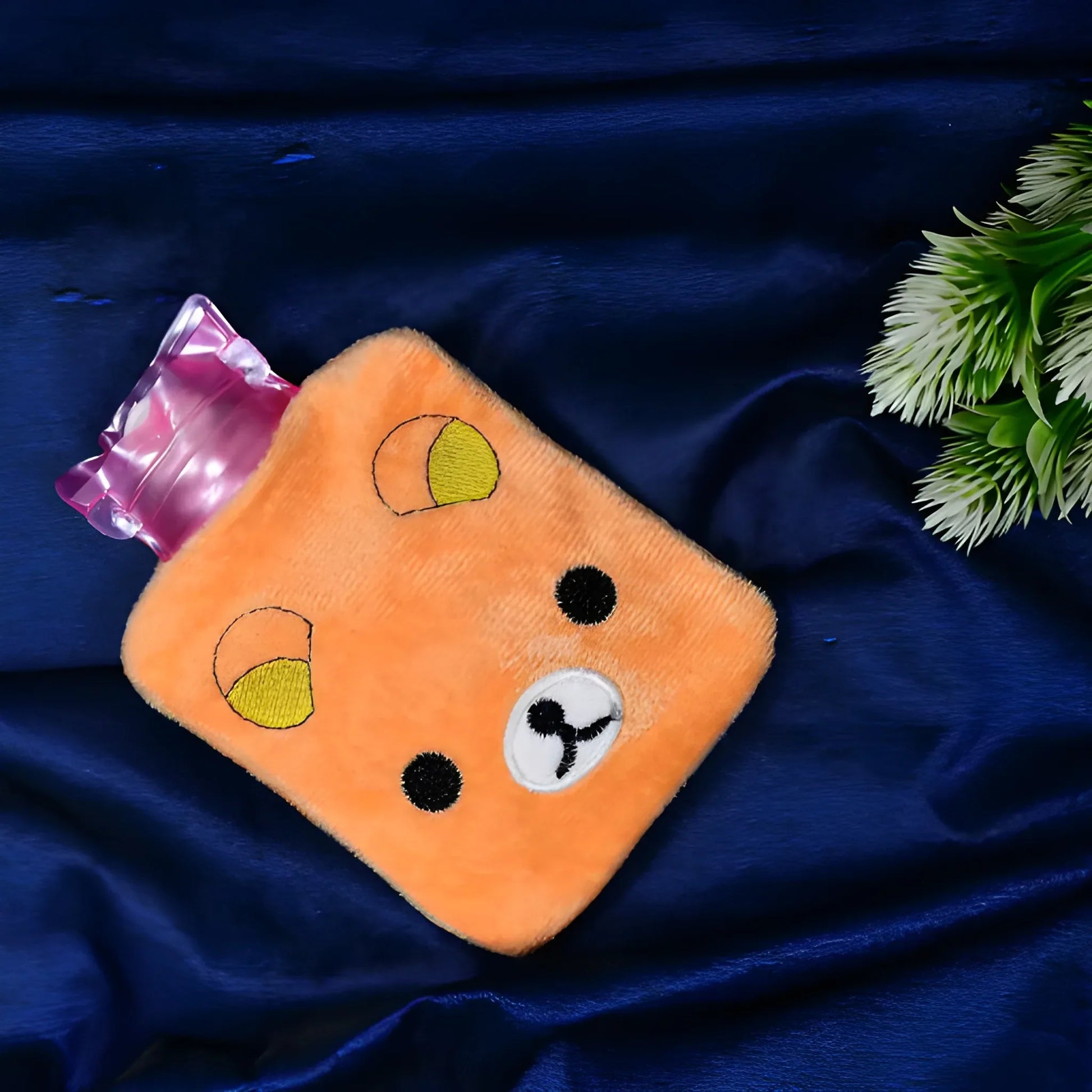 Plush pain relief hot bag in orange with paw print face and black dots, plus pink gel pack