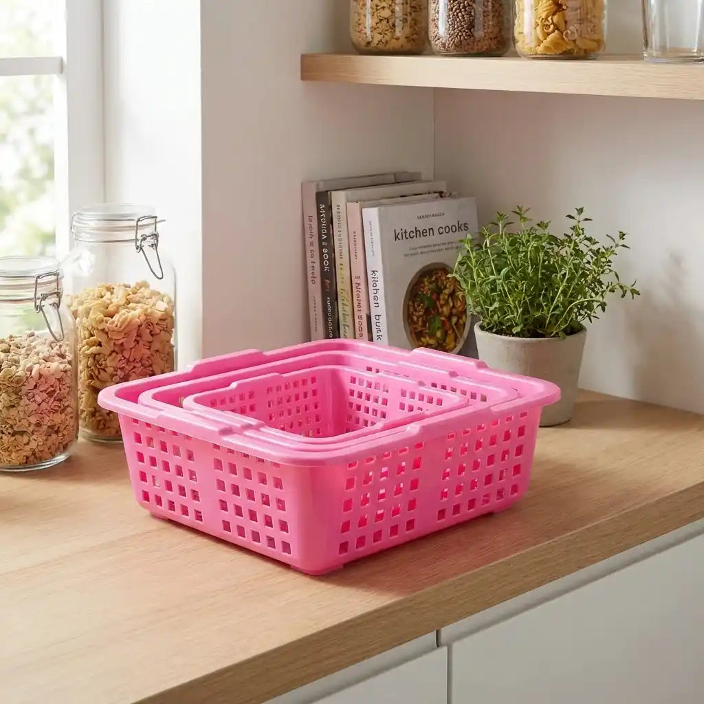 Plastic fruit basket with perforated sides in pink, rectangular open bin