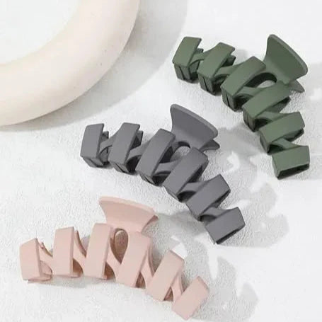 Plastic hair clamps in dark green, gray, and light pink, multi-clip set