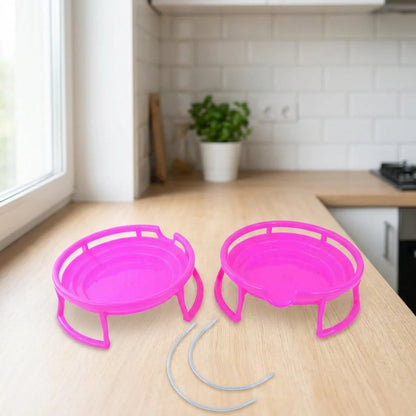 Two bright pink plastic water pot stands with curved feet and carrying handles