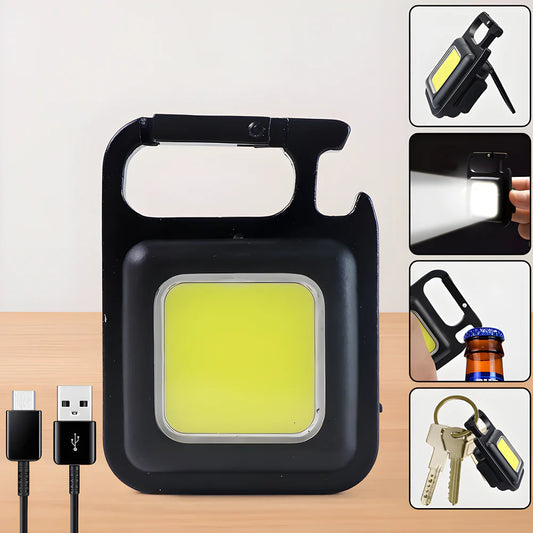Pocket keychain flashlight with black housing and bright yellow LED lens window