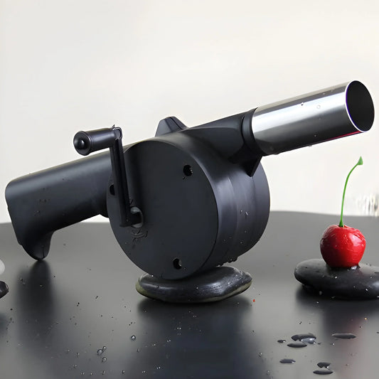 Portable hand crank air blower fan with black nozzle, silver barrel, and crank handle
