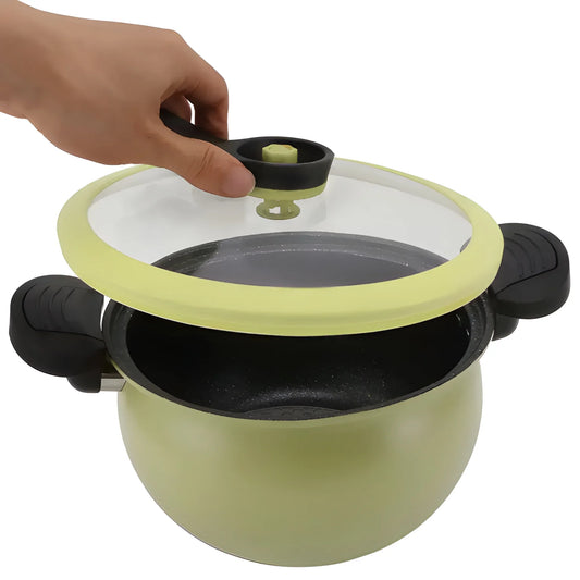 Pressure cooker safety valve with green cap on black lid