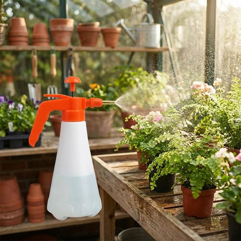 Pressure sprayer bottle with orange trigger, white body, mist spray over plants