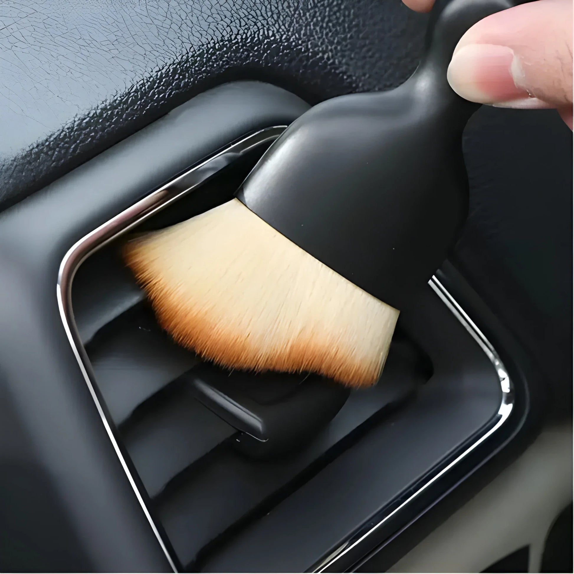 Dust brush with tan bristle head and black handle, angled for detailing