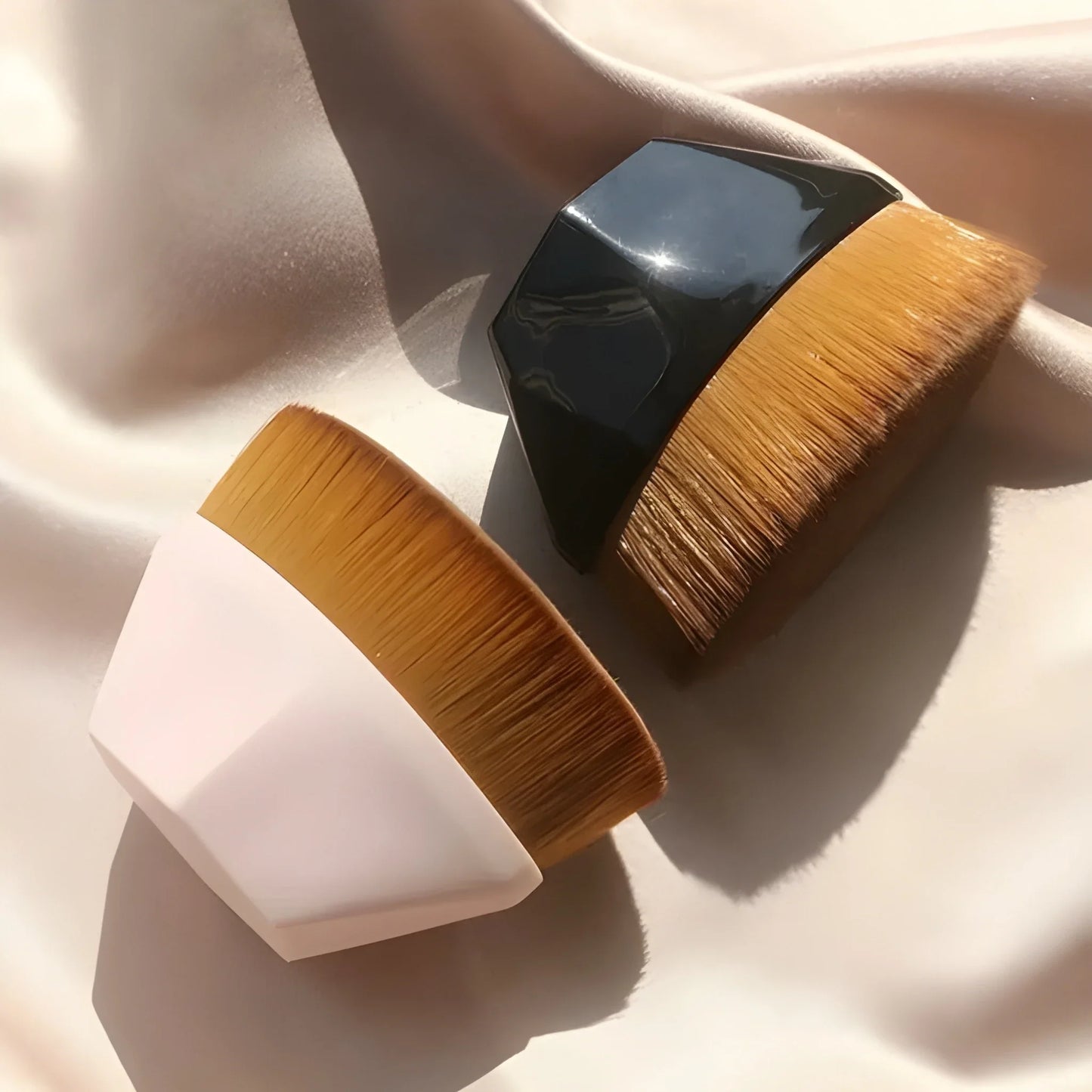 Foundation makeup brush with dense golden bristles and black handle ferrule