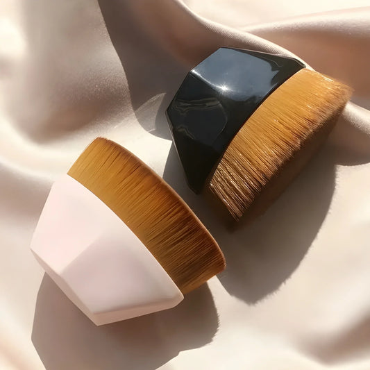 Foundation makeup brush with dense golden bristles and black handle ferrule
