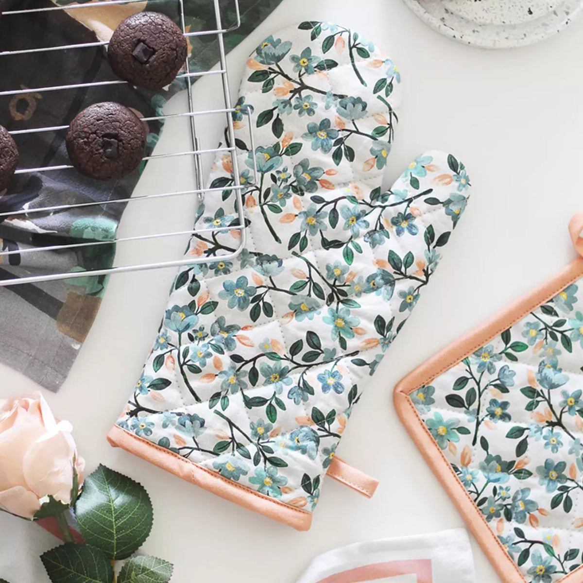 Floral cotton oven mitt with leafy pattern and long cuff, hanging loop