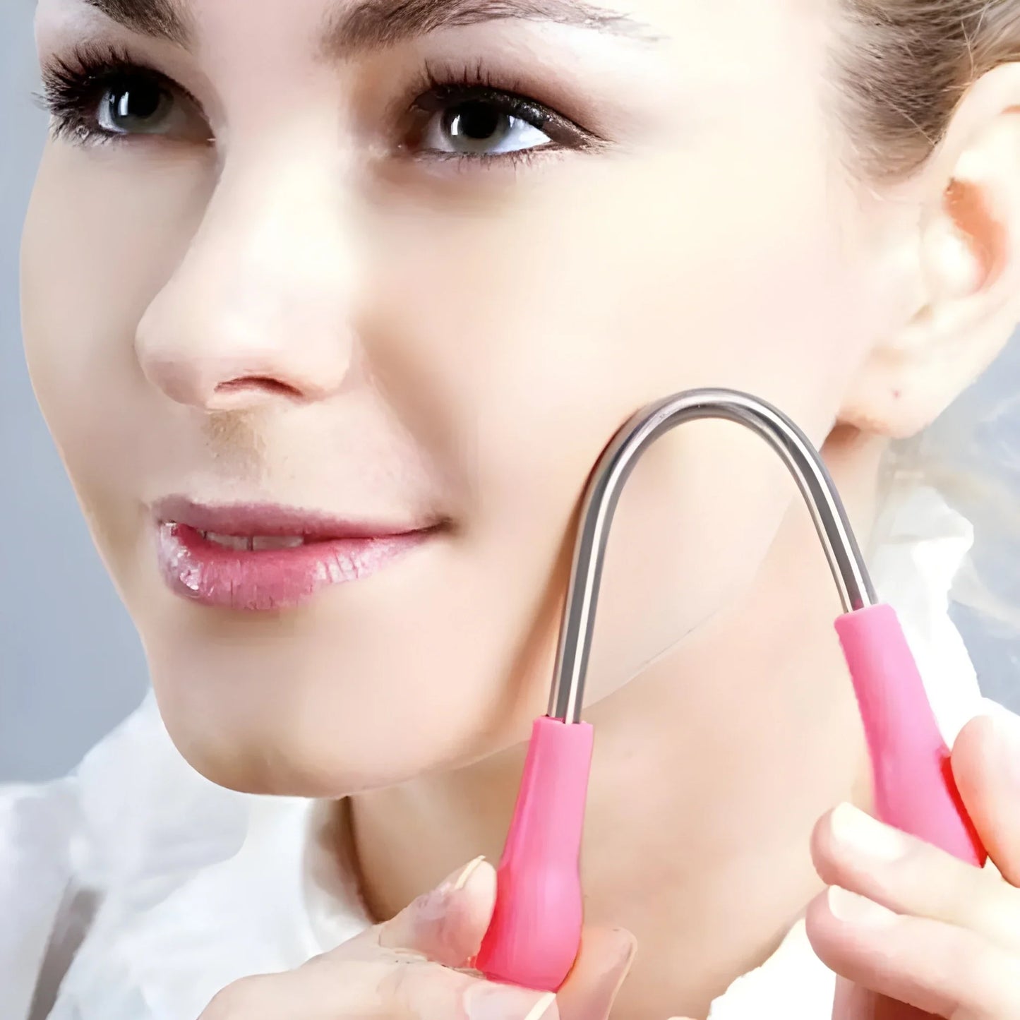 Nose wax applicator tool with pink handle and metal loop