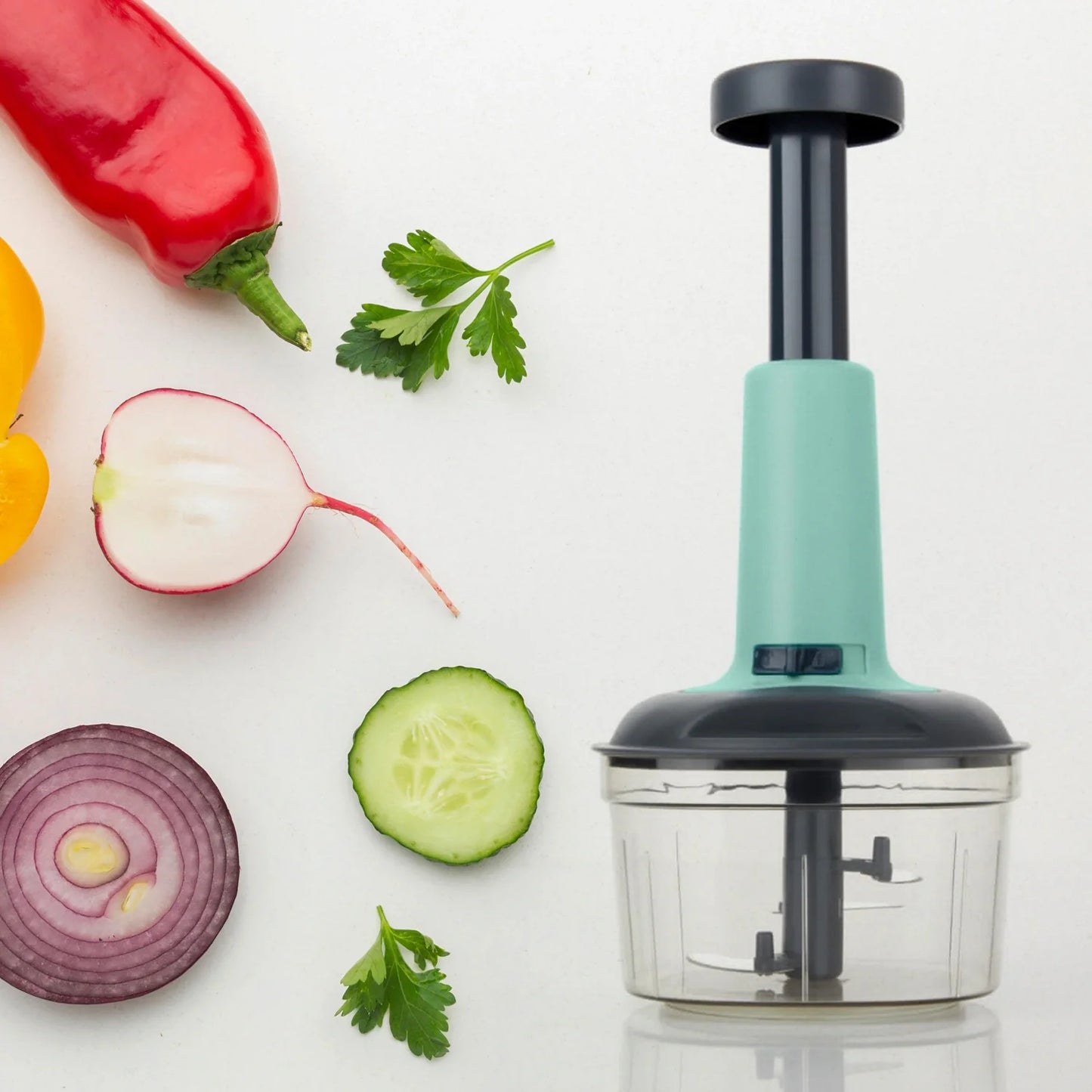 Three-blade push chopper with mint handle and clear cutting bowl