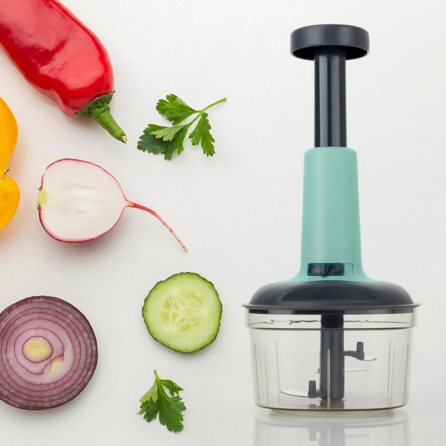 Three-blade push chopper with mint handle and clear cutting bowl