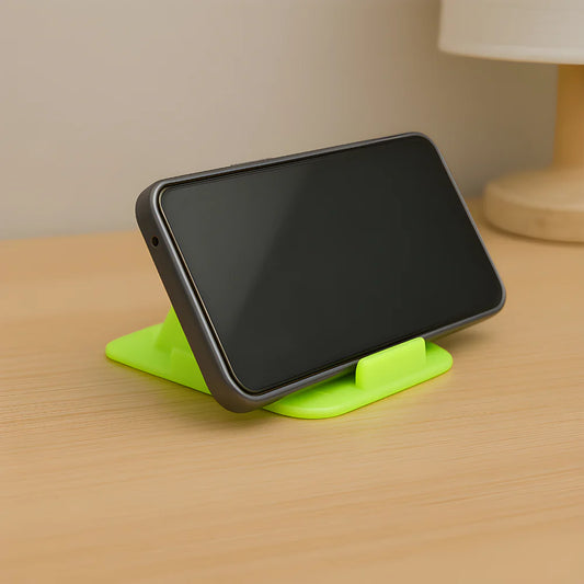 Pyramid dashboard phone holder with green pyramid base holding a dark smartphone