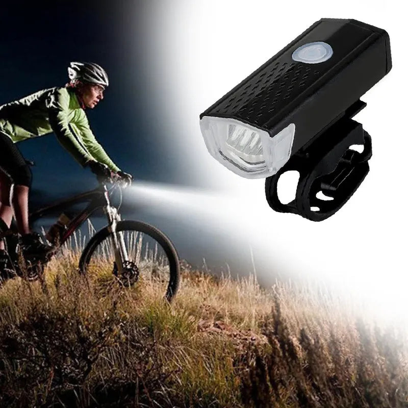 Rechargeable bicycle light with black housing and white lens, mounted on bike front.