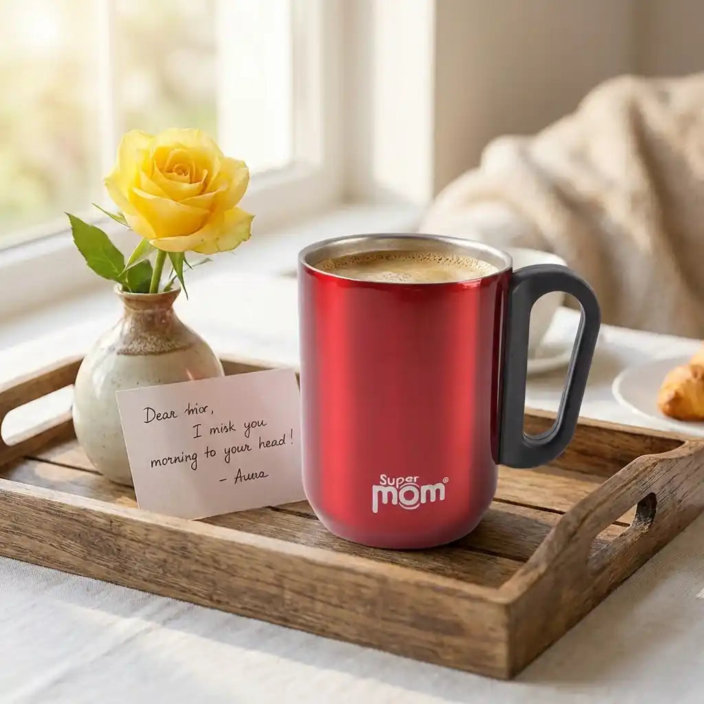 Red steel coffee mug with black handle, "super mom" logo, coffee inside