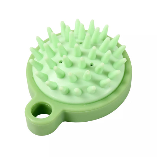 Green scalp massage brush with silicone bristles and circular handle