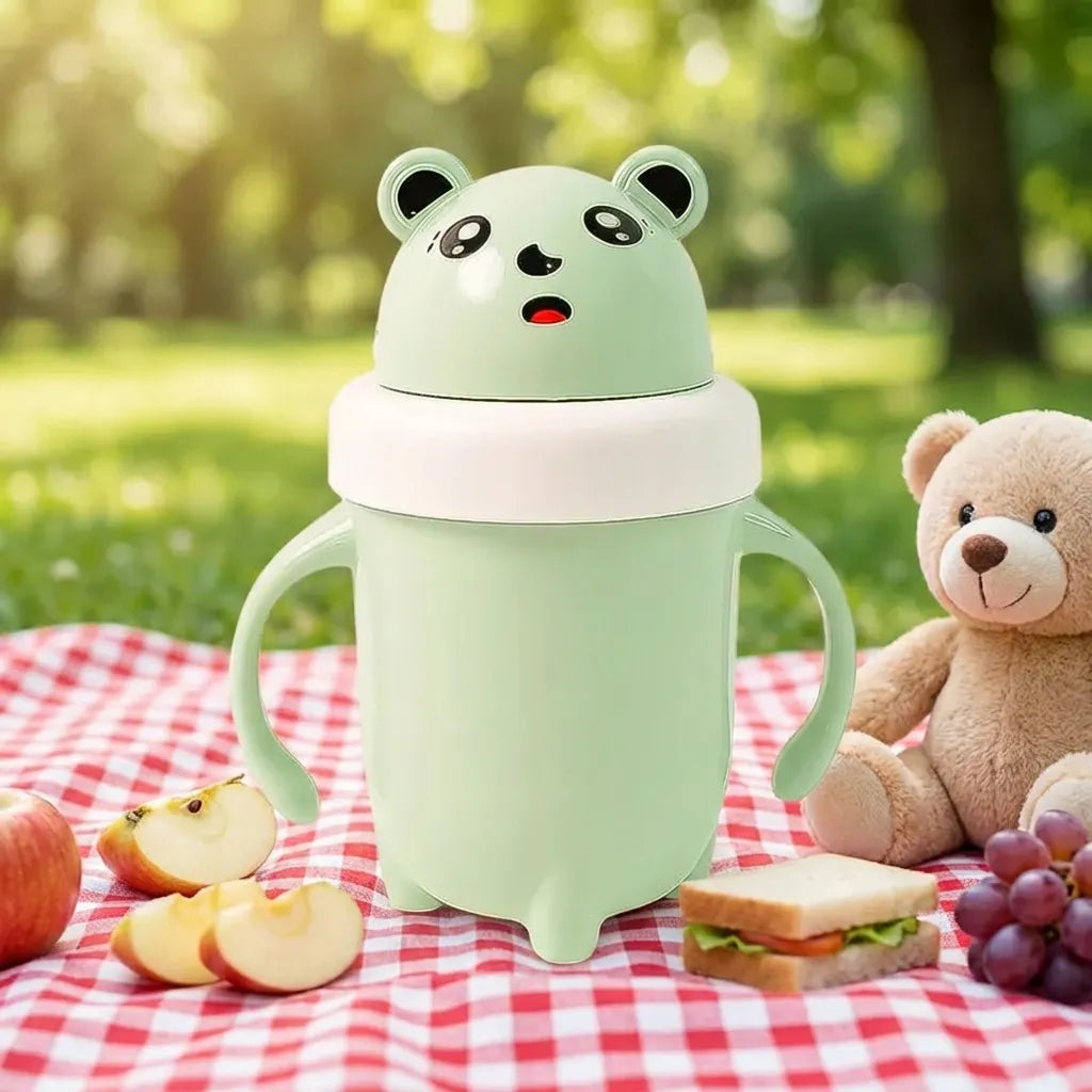Light green panda baby sipper cup with flip lid and curved side handles.