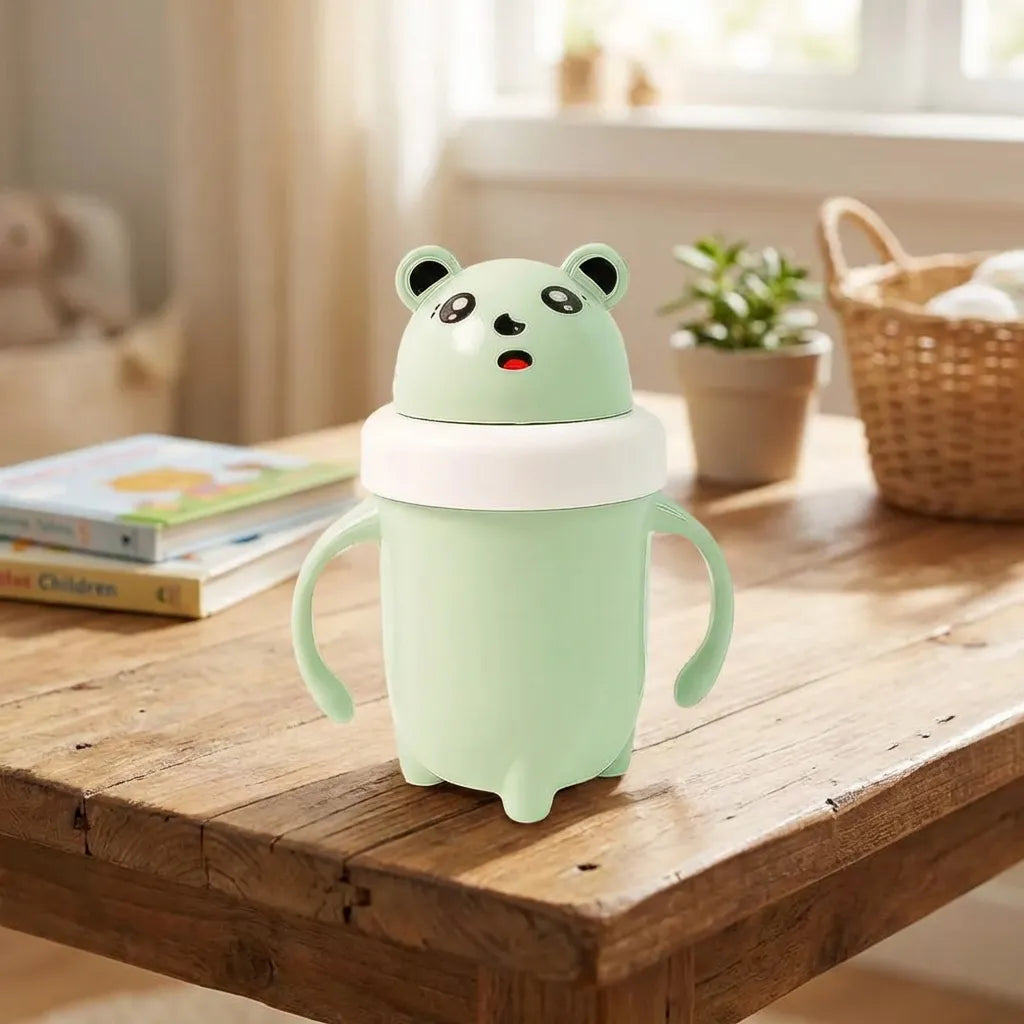 Light green panda baby sipper cup with loop handles and snap-on lid.