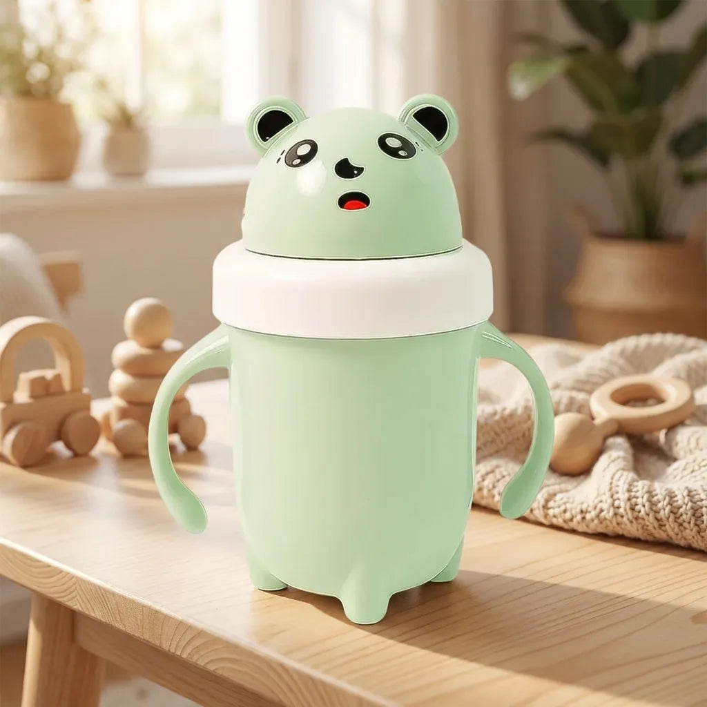 Light green baby sipper cup with panda face lid and curved side grips.