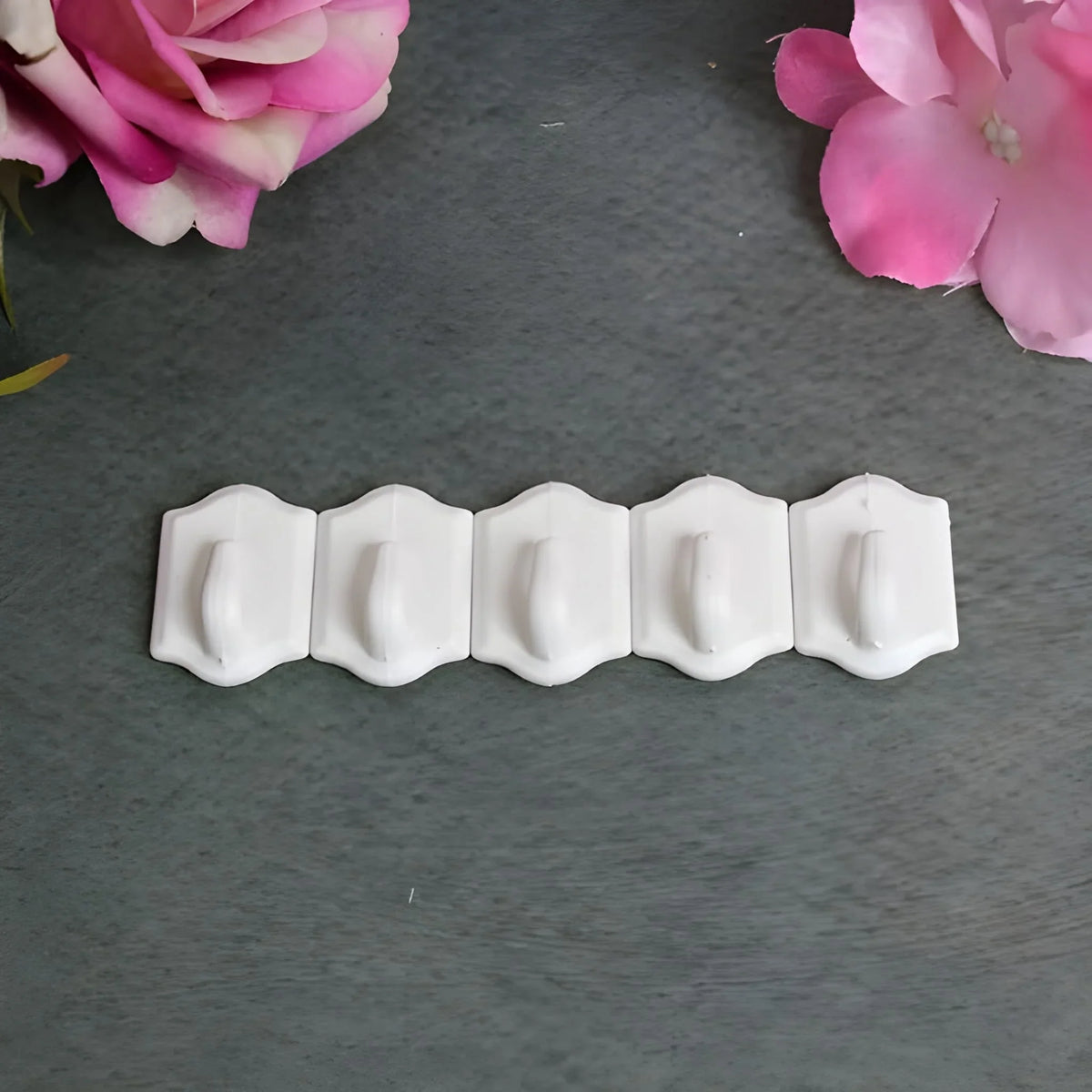 Set of small white wall hooks with curved ends