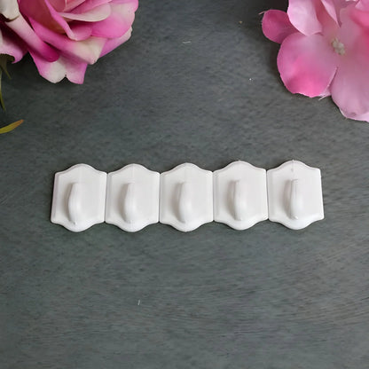 Set of small white wall hooks with curved ends