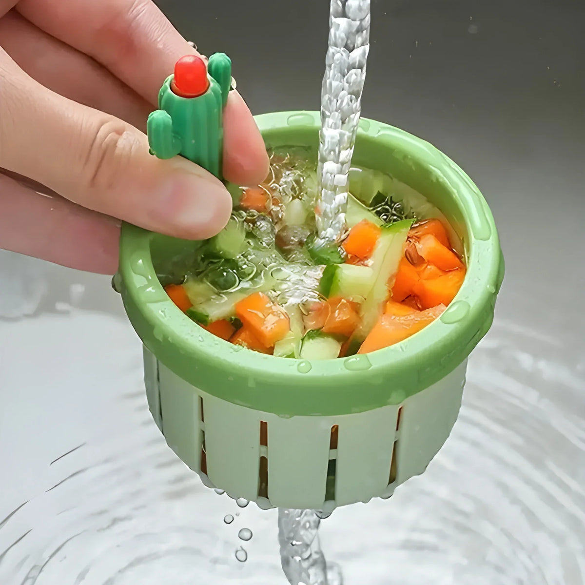 Green Smart Eco strainer basket, hand holding as water drains