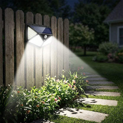 Solar wall light on wooden fence with LED beams lighting walkway