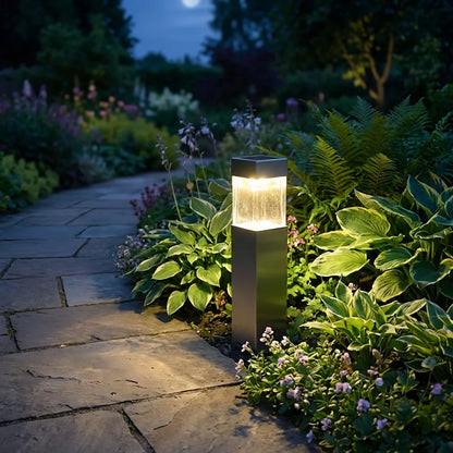 Solar pathway garden light, dark rectangular post with warm glow on ground