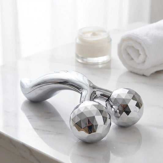 Solar-powered facial massager with two diamond-pattern roller heads, chrome finish
