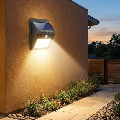 Solar motion LED wall light with upturned solar panel and bright front LED
