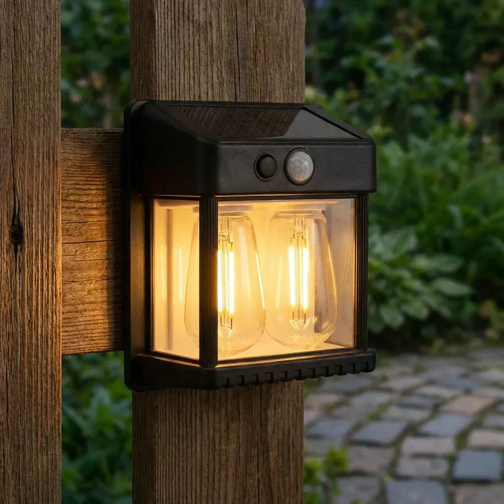 Solar wall motion light, black lantern with circular sensor and warm glowing bulb