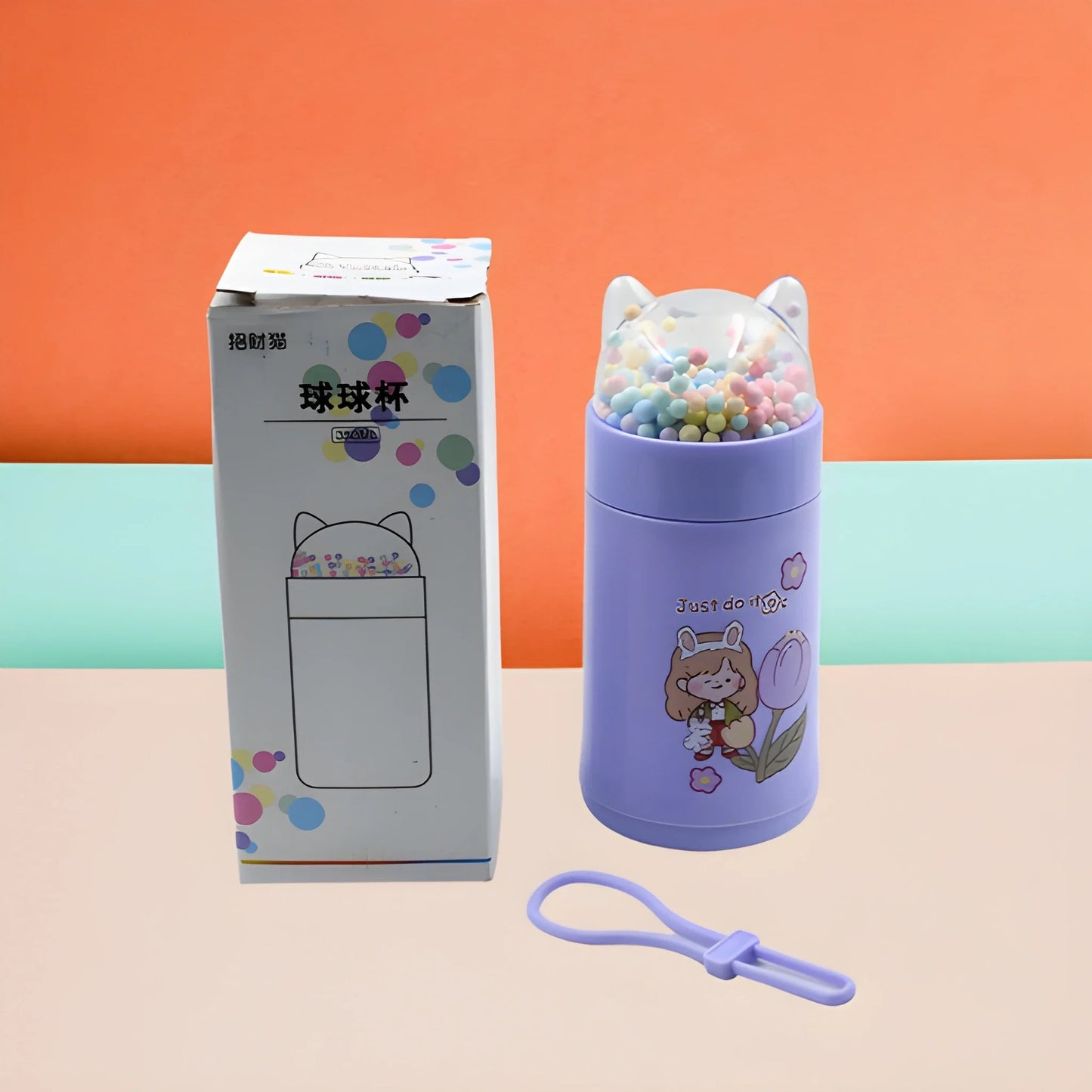 Cat-themed purple glass bottle with beads inside, screw lid and carrying loop.