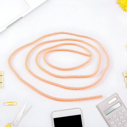 Spiral cable protector sleeve in orange, coiled length for protecting cables