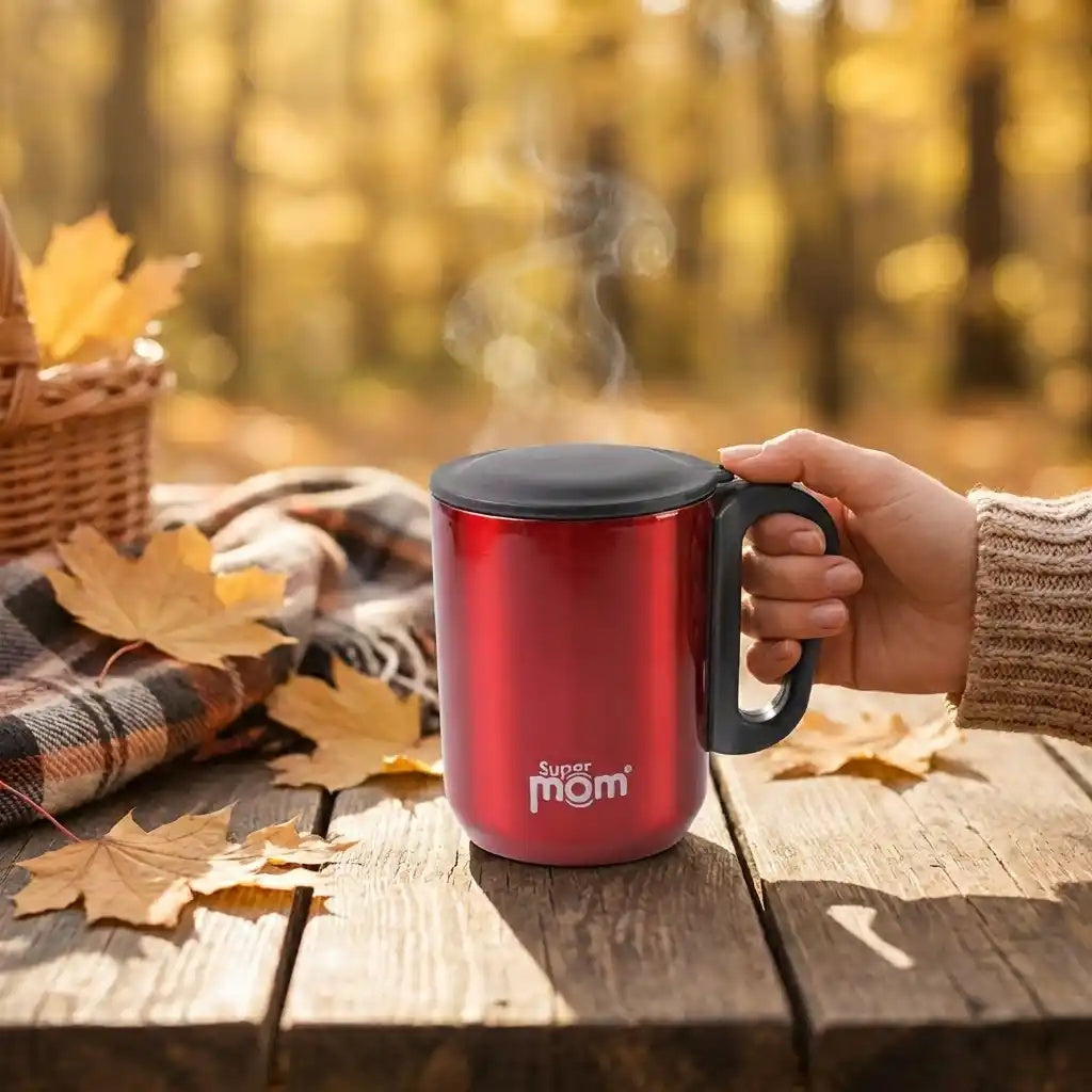 Square water jug in red with black lid and side handle; hand holds the mug