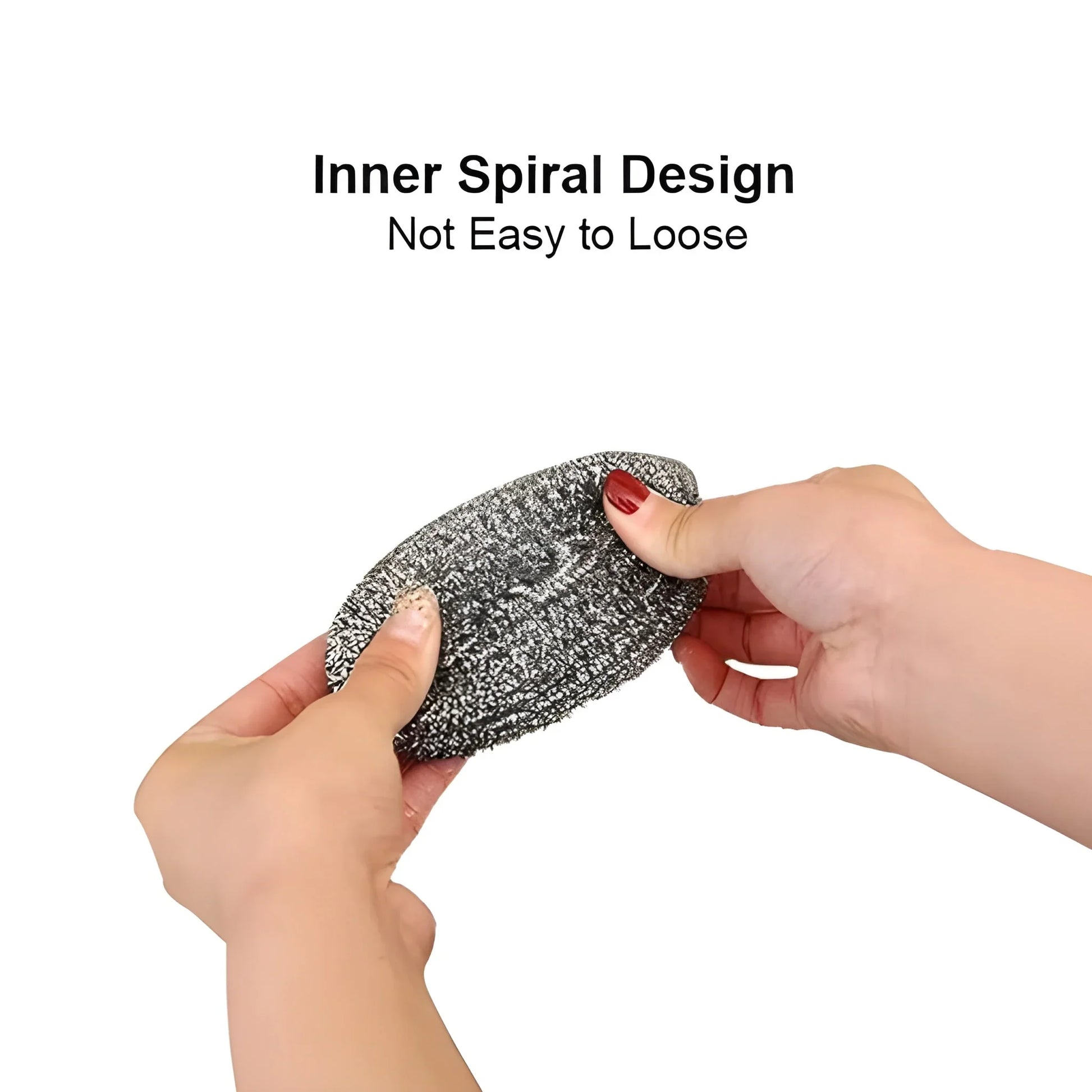 Stainless steel ball scrubber with textured spiral surface, held in hands