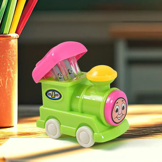 Green toy train pencil sharpener with pink top and smiling face on the side