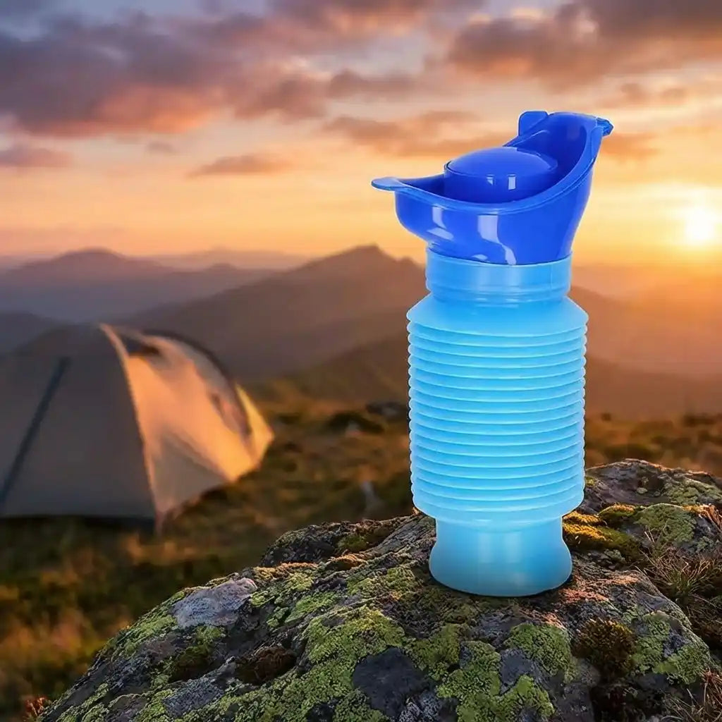 Blue foldable portable urinal bottle with open spout on rocky ground
