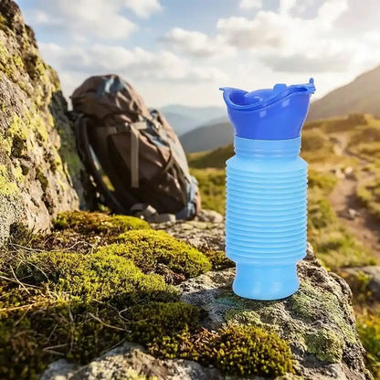 Blue foldable portable urinal bottle on mossy rock with spout opening