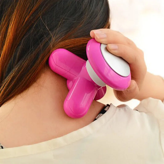 Pink full body handheld massager with white head, pressing on neck and shoulder