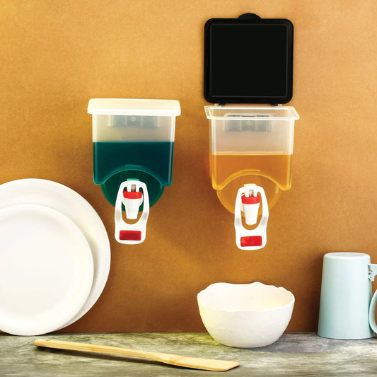 Wall-mounted oil dispensers with clear reservoirs, green and amber tanks, white pump nozzles