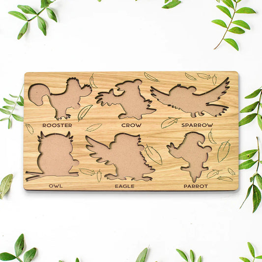 Wooden bird-shaped puzzle learning board with eight animal silhouettes and printed names
