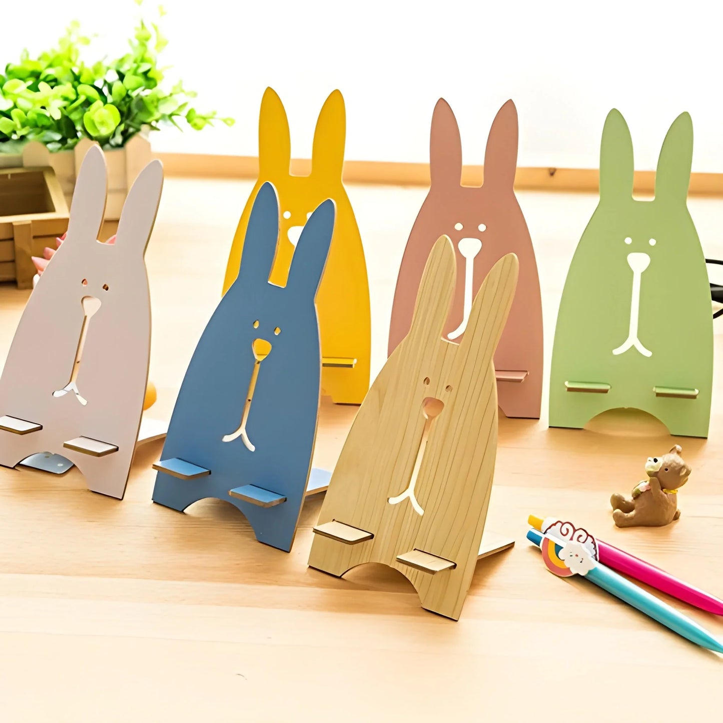 Rabbit phone stand set with cutout bunny faces, beige, blue, brown, tan, and green